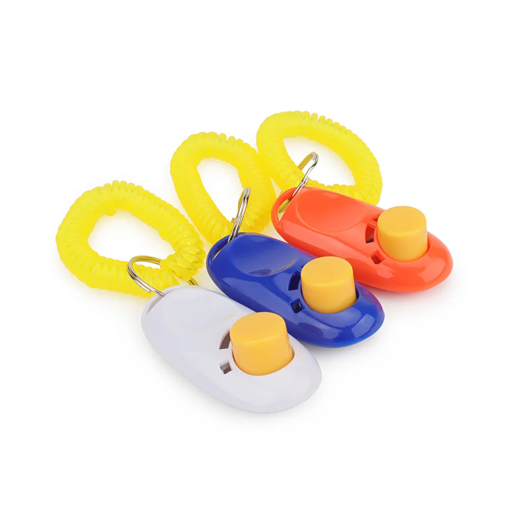 A set of dog training clickers in yellow, orange, and blue colors with attached keychains.
