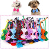 A collection of colorful adjustable pet bow ties for dogs and cats, including pink, blue, orange, and green.