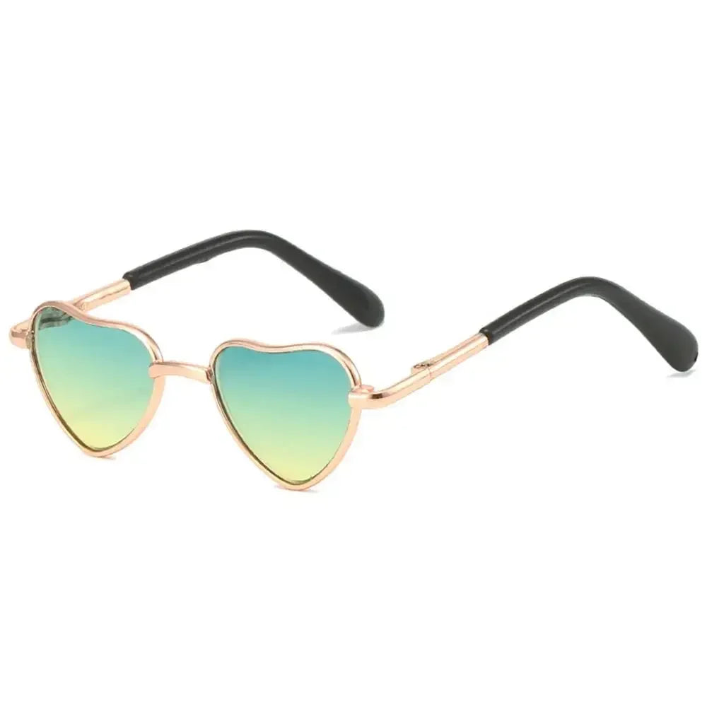 Funny heart-shaped pet sunglasses with light green lenses and gold-toned frames
