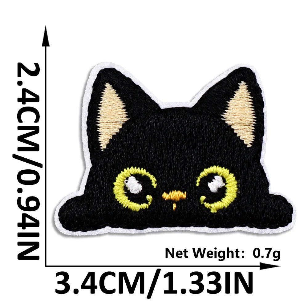 Black cat embroidered iron-on patch with yellow accents on a white background.