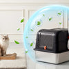 A stainless steel dog proof litter box is shown with a glowing blue protective field surrounding it, next to a cat.