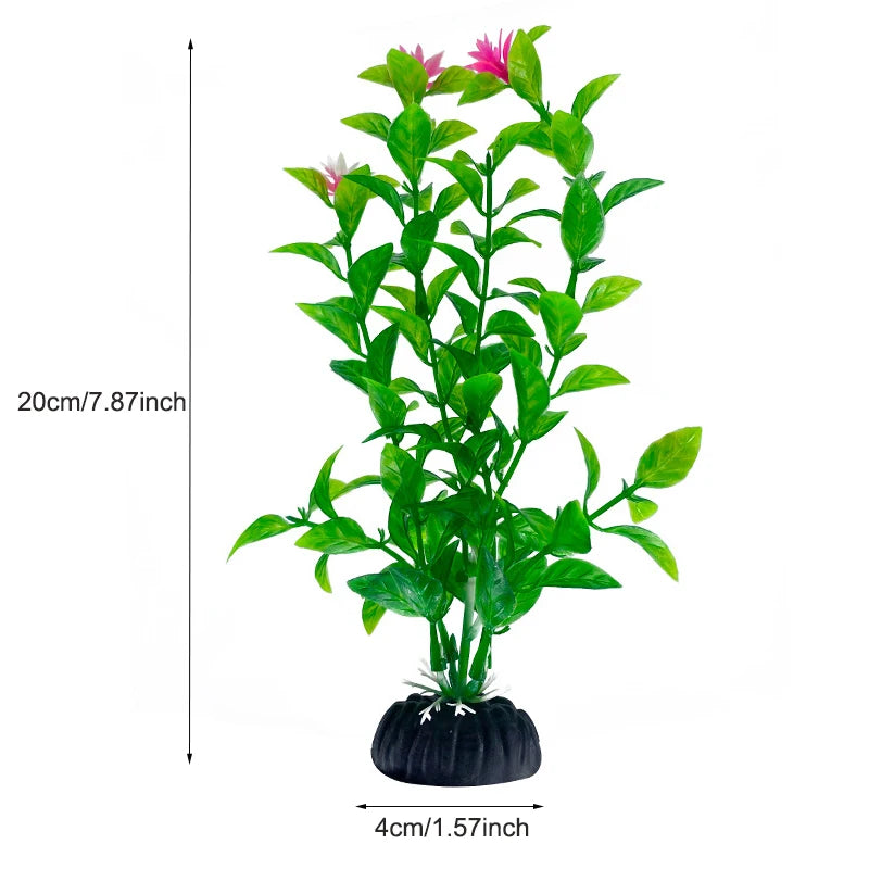 Plante aquatique artificielle verte éclatante avec des fleurs roses, dans un pot noir.