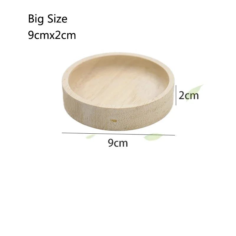 A light wood feeding bowl measuring 9cm by 2cm.