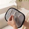 A hand is demonstrating pet hair removal gloves for dogs and cats, showing the soft, gray fabric and black trim.