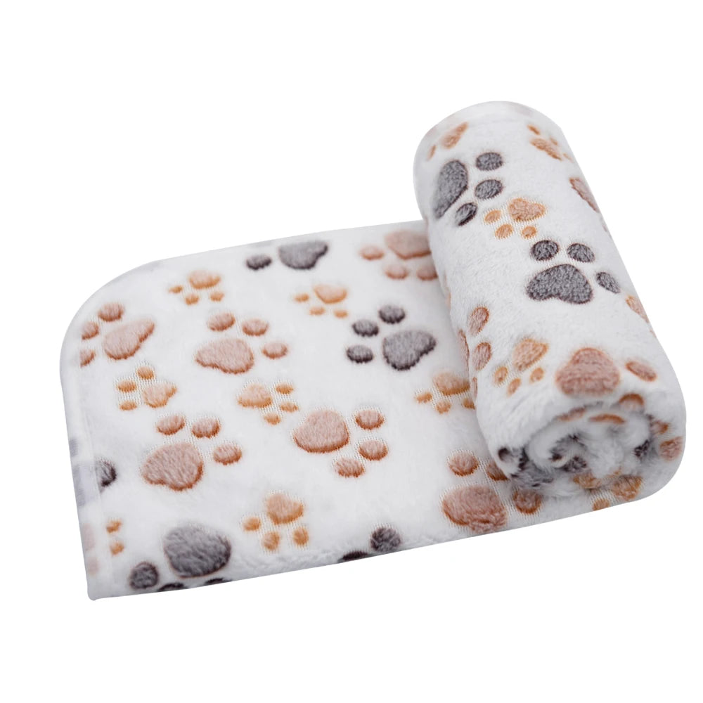 Rolled white pet mat with gray and tan paw print patterns