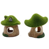 A miniature resin aquarium house decor featuring a green mossy tree shelter for small fish and shrimp.