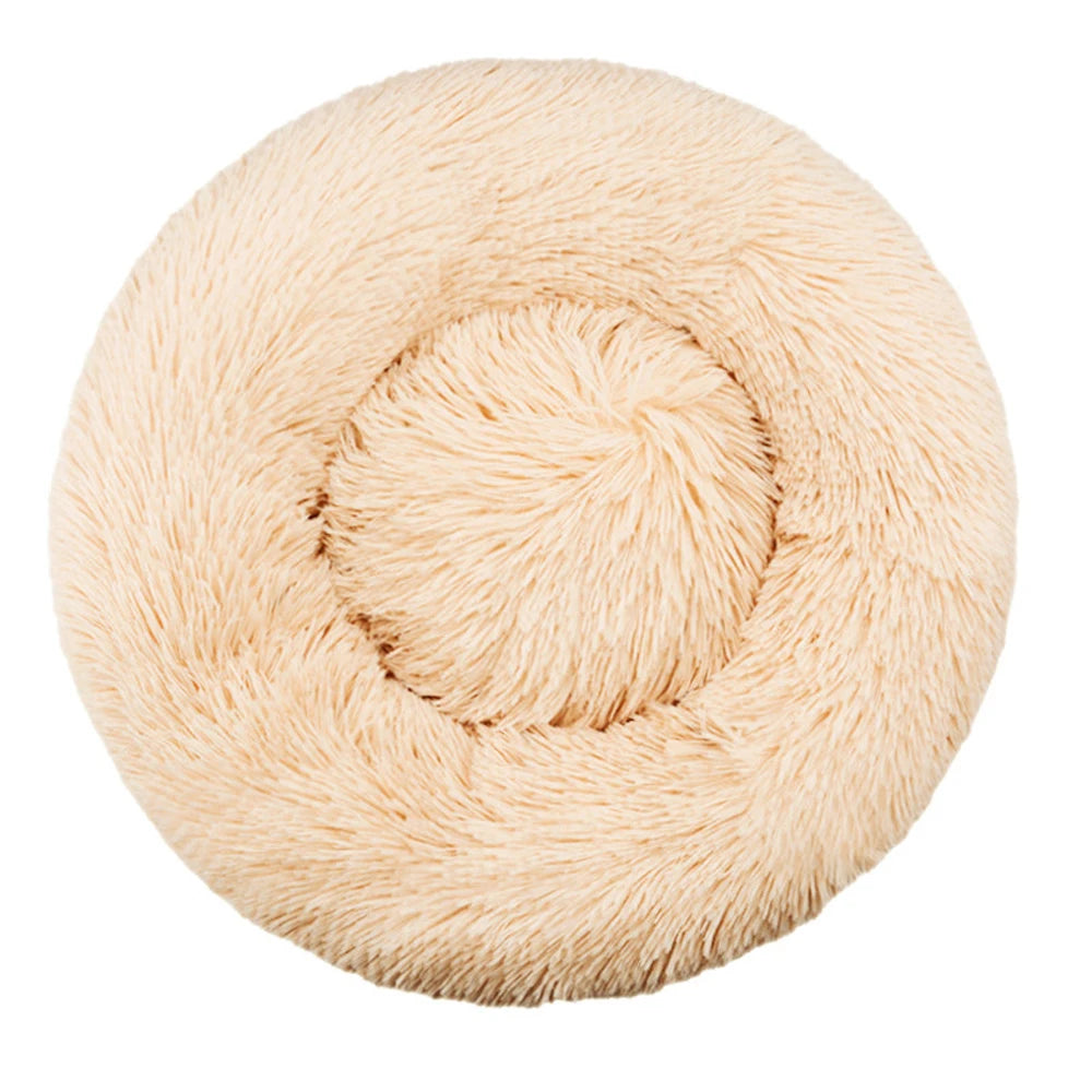 A round, light beige plush pet bed for dogs and cats.