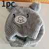A gray knitted dog scarf and hat set with bear ears.