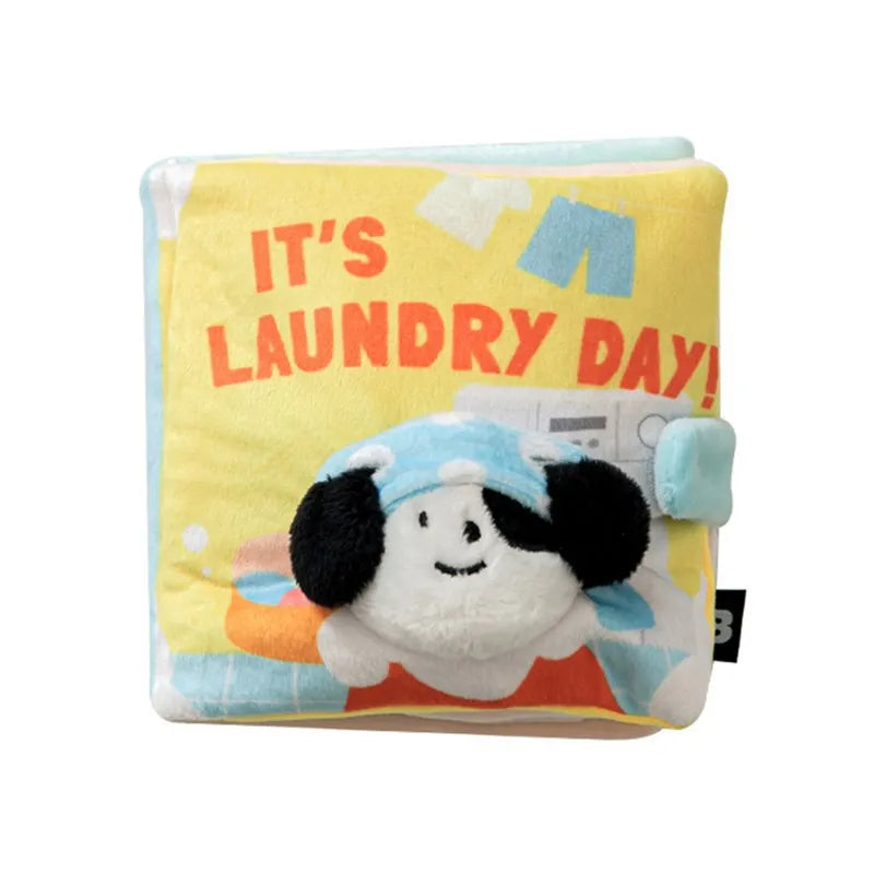 A yellow fabric toy with text on it, featuring a cute animal design.