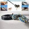 A yellow and blue braided bungee tug toy for dogs lying on a white surface.