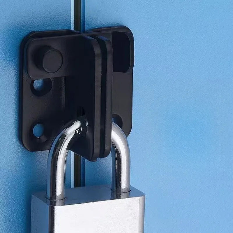 A black sliding bolt lock mechanism mounted on a light blue wall, featuring a metal handle.