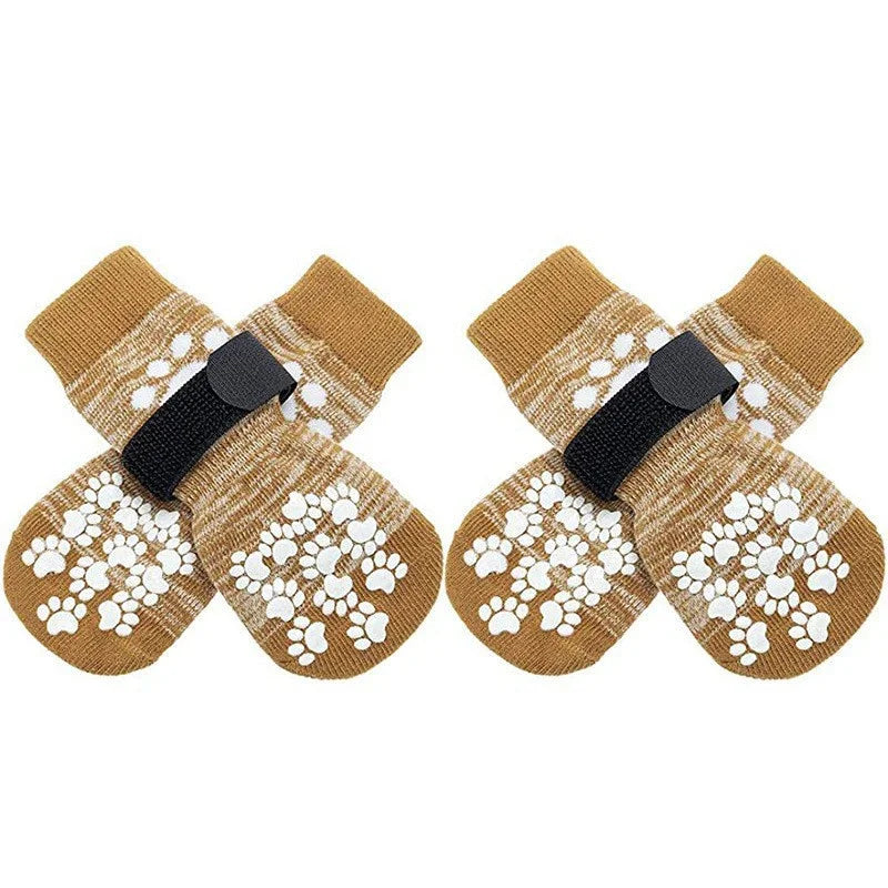 Pair of tan and white anti-slip dog socks with traction straps
