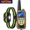 A black waterproof dog training collar with a yellow display and a green patterned strap.