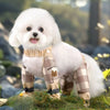 A fluffy white dog wearing adjustable reflective pet strolling pants with a plaid pattern.