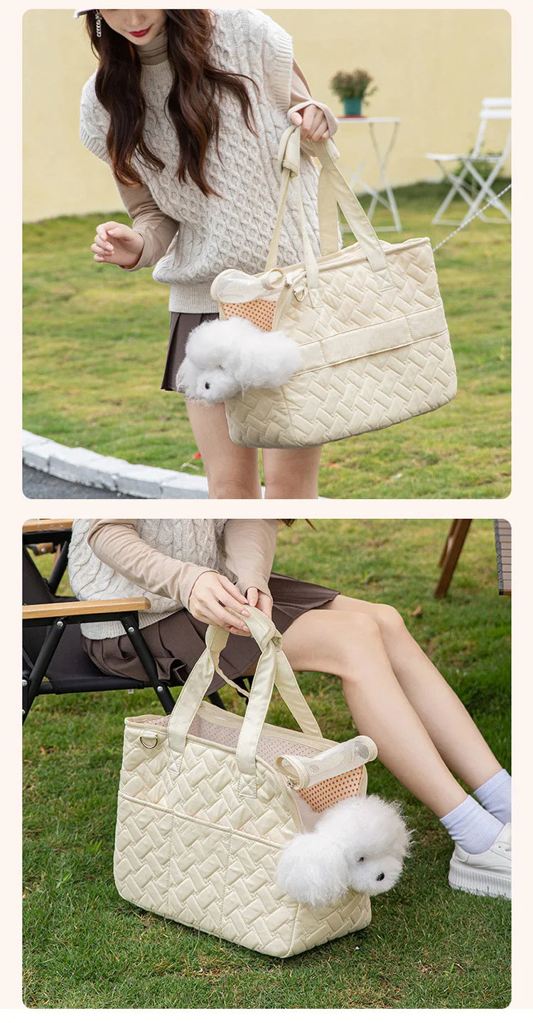 A beige quilted portable pet carrier bag with light cream handles and a fluffy white pom-pom, shown in outdoor settings.