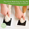 Hands placing a paw print on a card, demonstrating the ease of making pet paw prints.