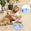 A young girl is interacting with a golden retriever dog and a blue puzzle toy with a non-slip base.