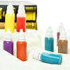A collection of glass liquid droppers in various colors including yellow, pink, orange, purple, and blue, displayed on a whit