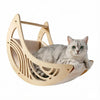 A gray cat is relaxing in a wooden wall hammock with climbing steps and a moon bed.