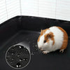 A white and orange guinea pig is shown inside a black PVC cage liner.