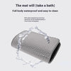 A gray double layer cat litter mat is shown with water dripping off it, demonstrating its waterproof property.