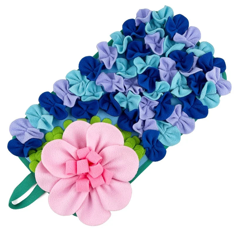 A colorful fabric mat featuring purple, blue, and teal flowers for interactive pet foraging.