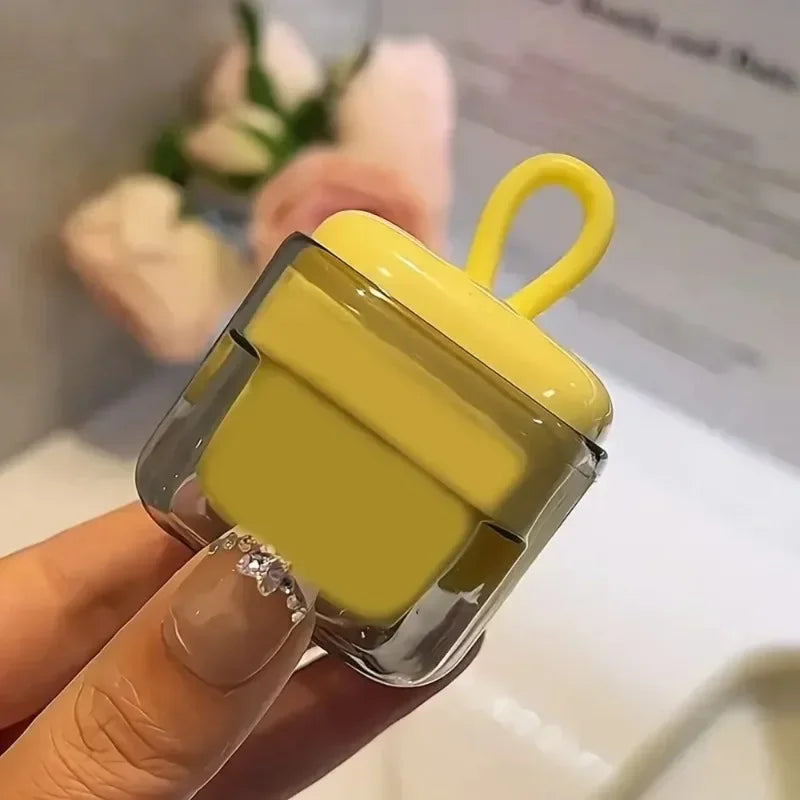 A hand holds a yellow portable lint roller with a clear casing and a yellow handle, used for pet hair removal.