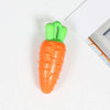 An orange carrot shaped squeaky chew toy for dogs with a green handle.