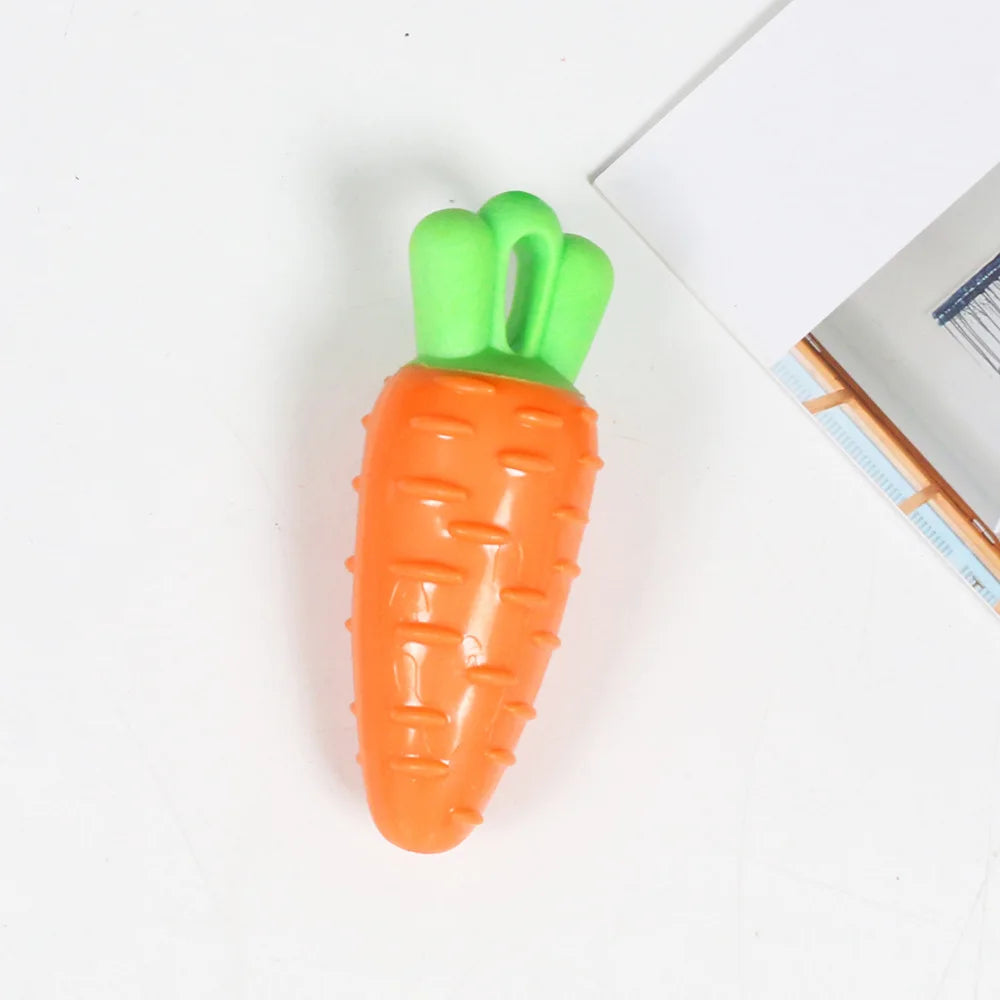 An orange carrot shaped squeaky chew toy for dogs with a green handle.