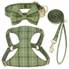 A green plaid dog collar, harness, and leash set with a bowtie.