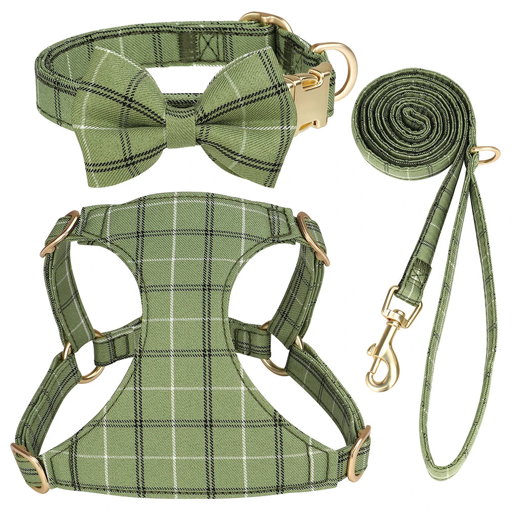 A green plaid dog collar, harness, and leash set with a bowtie.
