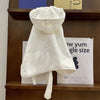 A white multi-purpose pet bath robe for dogs is displayed on a wooden shelf.