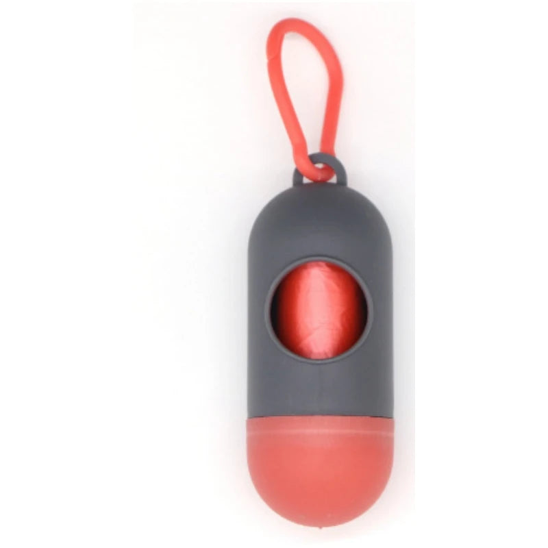 A capsule-shaped dog poop bag dispenser with a carabiner clip, featuring gray and red components.