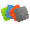 Three silicone licking mats for pets in green, blue, and orange with suction cups