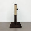 A tall, cylindrical sisal cat scratching post with a dark felt ball attached, set on a gray surface.