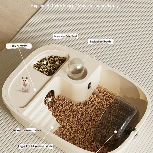 A luxury hamster habitat cage showing an expanded activity space with a food bowl, water bottle, play run, and a feed area.