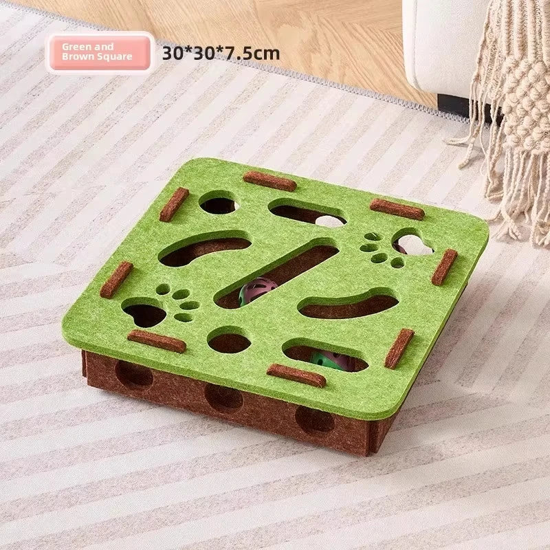 A green and brown square interactive cat puzzle toy with holes and tunnels for indoor play.