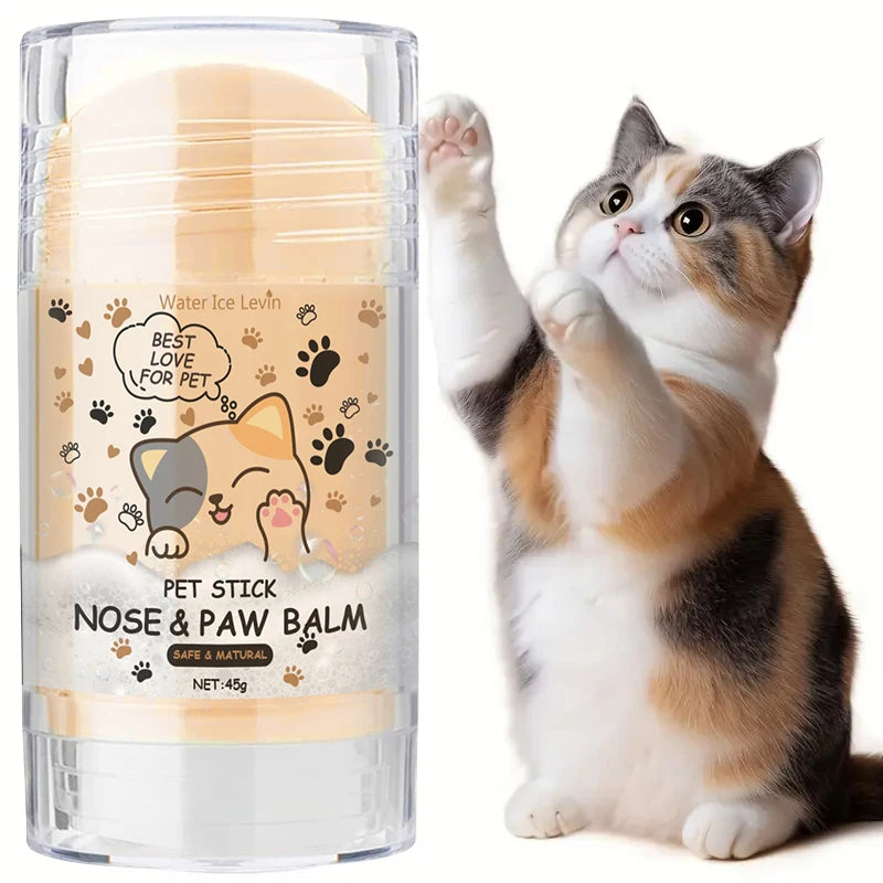 A fluffy orange and white cat raises a paw, next to a glass jar of Pet Stick Nose & Paw Balm.