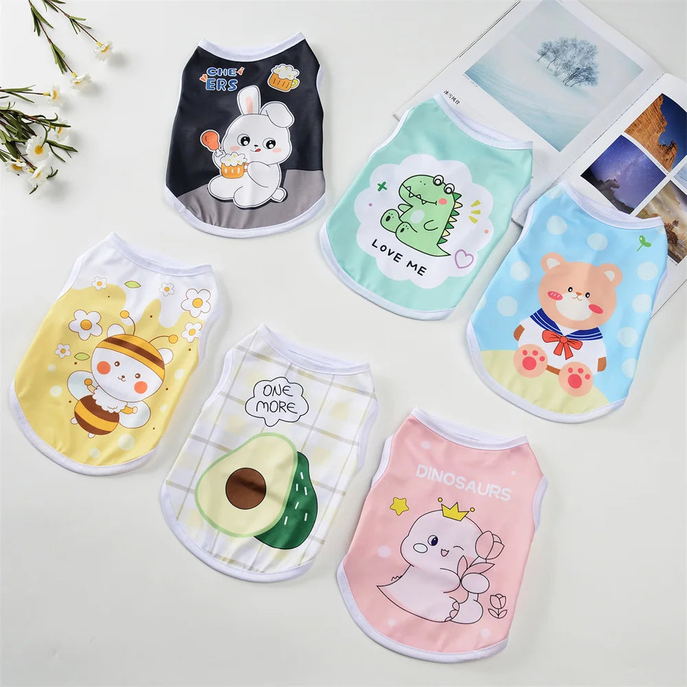 A collection of cute printed dog vests for small breeds featuring various designs like a white puppy, a green dinosaur, and a