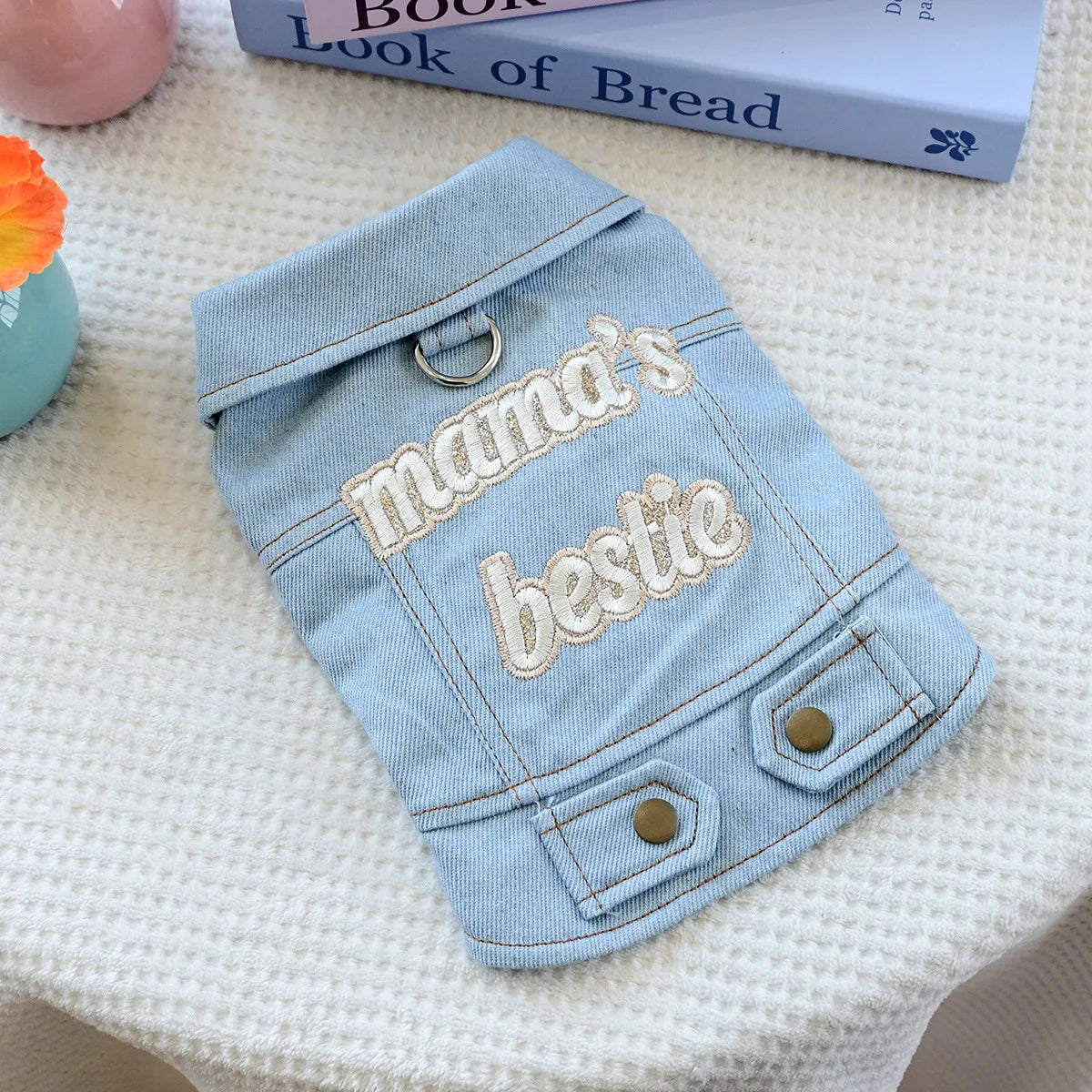 Light blue denim jacket for dogs featuring embroidered text that reads mama's bestie