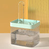 A clear glass water fountain with a light green top and a vertical carbon filter visible inside.