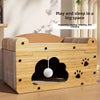 A wooden cat scratcher house and lounge bed with a padded cover and a spherical toy inside.