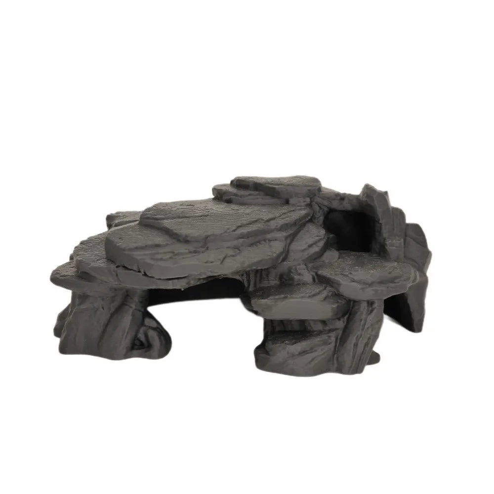 A dark gray, realistic 3D printed ornament shaped like a fish tank rockery.