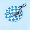 A blue and white checkered bucket hat with a black strap is shown against a light blue background.