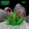 A clump of red and green artificial aquarium plants displayed in a natural stone setting.