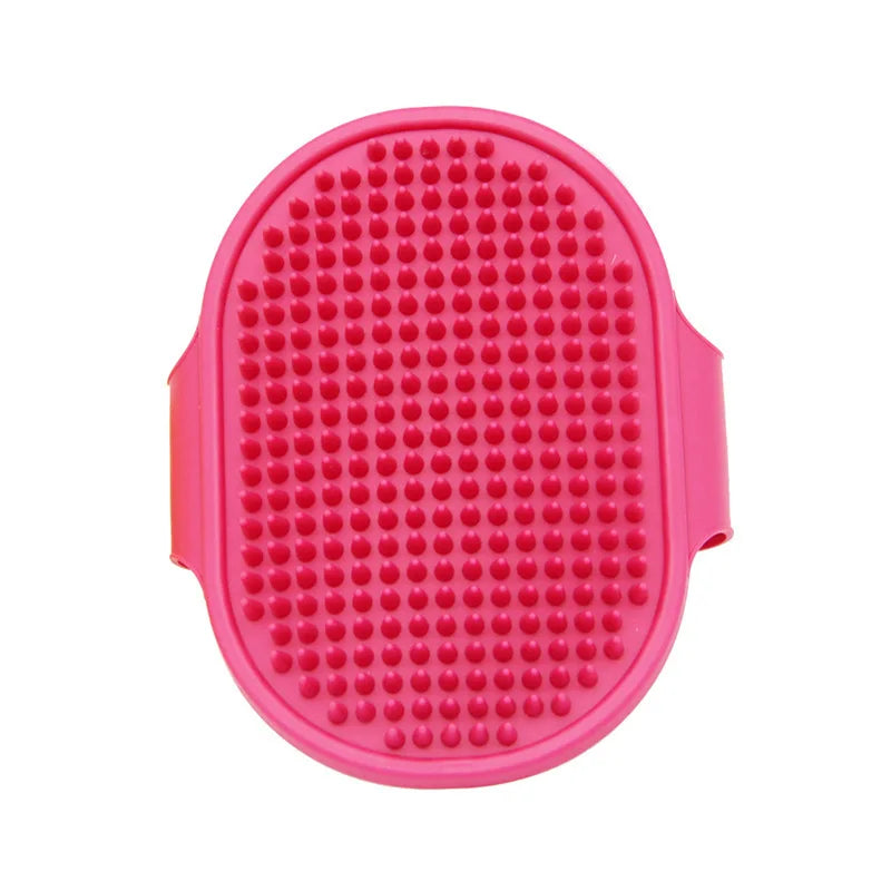 A bright pink soft rubber pet grooming brush with numerous small rubber bristles.
