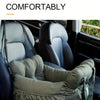 A green durable pet car seat with safety straps installed in a car interior.