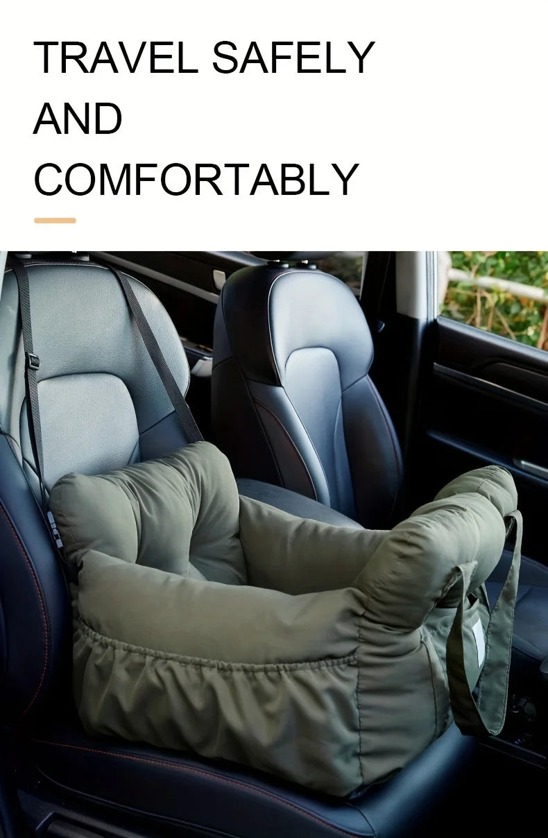 A green durable pet car seat with safety straps installed in a car interior.