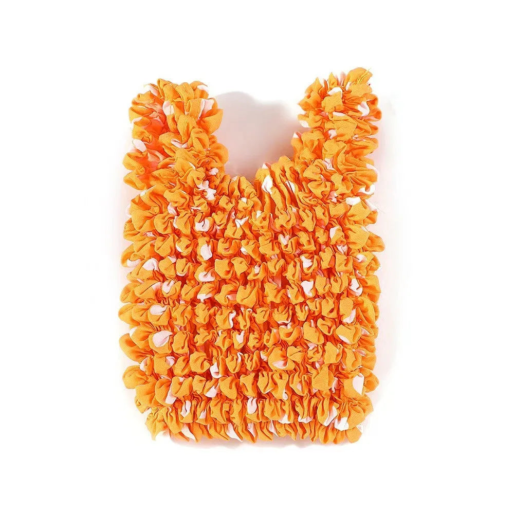 A bright orange reusable foldable bubble shopping bag made of crinkled paper.