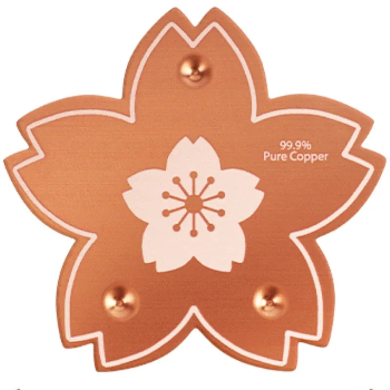 A round, copper-colored cleaning disc with a white flower design and four mounting holes.